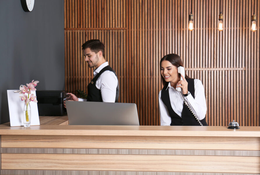 Receptionists,Working,At,Desk,In,Modern,Lobby Receptionists,Working,At,Desk,In,Modern,Lobby